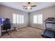 Bright home office features a standing desk, comfortable chair, and large windows at 351 Elder View Dr, Las Vegas, NV 89138