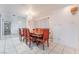 Bright dining room featuring a large wood table and six red chairs at 3829 Delaware Ln, Las Vegas, NV 89169
