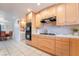 Updated kitchen with wood cabinets, gas cooktop and views into the dining area at 3829 Delaware Ln, Las Vegas, NV 89169