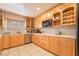 Modern kitchen featuring light wood cabinets, stainless steel appliances, and tile backsplash at 3829 Delaware Ln, Las Vegas, NV 89169