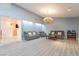 Spacious living room with plush seating, a coffee table, and a stunning chandelier at 3829 Delaware Ln, Las Vegas, NV 89169