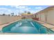 Long rectangular pool with surrounding patio and shade sail at 3829 Delaware Ln, Las Vegas, NV 89169