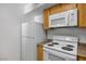 The kitchen features white appliances including a microwave and electric stove at 45 Maleena Mesa St # 223, Henderson, NV 89074
