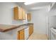 This kitchen features light cabinets and white appliances, plus a breakfast bar at 45 Maleena Mesa St # 223, Henderson, NV 89074