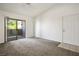 Living room featuring neutral carpet, a ceiling fan, and a sliding glass door to the outside at 45 Maleena Mesa St # 223, Henderson, NV 89074