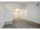 Living room featuring neutral carpet, a partial wall, and open access to other rooms at 45 Maleena Mesa St # 223, Henderson, NV 89074