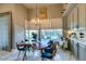 Bright breakfast nook features a live-edge wood table and chairs, offering pool views at 4702 Blue Mesa Way, Las Vegas, NV 89129