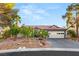 White house with red tile roof, landscaped yard, and two-car garage at 4920 Rancho Bernardo Way, Las Vegas, NV 89130