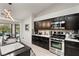 Modern kitchen boasting stainless steel appliances, dark cabinetry, and a large island at 4920 Rancho Bernardo Way, Las Vegas, NV 89130