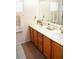 Bathroom with double sinks, gold fixtures, and wood cabinets at 5402 Cross Meadows Ln, Las Vegas, NV 89122