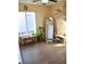 Bright bedroom with large window, plant, and full-length mirror at 5402 Cross Meadows Ln, Las Vegas, NV 89122