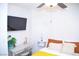Bedroom with a TV, desk, and yellow bedding at 5402 Cross Meadows Ln, Las Vegas, NV 89122