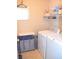 Laundry room with washer, dryer, and storage shelves at 5402 Cross Meadows Ln, Las Vegas, NV 89122