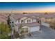 Two-story house with tile roof, two-car garage, and desert landscaping at 6005 Bristol Crest Ln, Las Vegas, NV 89139