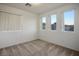 Bright bedroom with neutral carpeting and large windows offering ample natural light at 6005 Bristol Crest Ln, Las Vegas, NV 89139