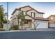 Two-story house with attached garage and desert landscaping at 6005 Bristol Crest Ln, Las Vegas, NV 89139