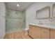 Bathroom with walk-in shower, modern vanity, and marble tile at 8645 Edmond St, Las Vegas, NV 89139