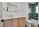 Stylish bathroom with a modern vanity and green tile shower at 8645 Edmond St, Las Vegas, NV 89139