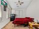 Cozy bedroom with a red and black plaid comforter and ample natural light at 8811 Pauley Hills St, Las Vegas, NV 89131