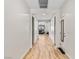 Bright hallway with light wood flooring, leading to living areas at 8811 Pauley Hills St, Las Vegas, NV 89131