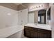 Clean bathroom with white tiled tub and dark vanity at 9000 Las Vegas Blvd # 2134, Las Vegas, NV 89123