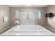 Luxurious bathroom with soaking tub, glass shower, and chandelier at 9622 Aqua Harbor Way, Las Vegas, NV 89178