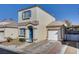 Two-story house with blue door and attached garage at 10082 Swimming Hole St, Las Vegas, NV 89183