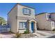 Two-story house with blue door and attached garage at 10082 Swimming Hole St, Las Vegas, NV 89183