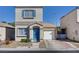 Two-story house with blue door and attached garage at 10082 Swimming Hole St, Las Vegas, NV 89183