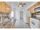 Bright kitchen features granite countertops, wood cabinets, and tile flooring at 10082 Swimming Hole St, Las Vegas, NV 89183