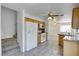 Kitchen with wood cabinets, tile floor, and view of staircase at 10082 Swimming Hole St, Las Vegas, NV 89183