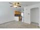 Open living area with kitchen view and ceiling fan at 10082 Swimming Hole St, Las Vegas, NV 89183