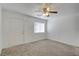 Living room with neutral carpet and ceiling fan at 10082 Swimming Hole St, Las Vegas, NV 89183