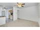 Open living area with kitchen view and ceiling fan at 10082 Swimming Hole St, Las Vegas, NV 89183