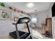 Bedroom with treadmill and built-in shelving at 10150 Timber Willow Ave, Las Vegas, NV 89135