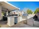 Outdoor kitchen and covered patio with seating area at 10150 Timber Willow Ave, Las Vegas, NV 89135