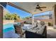 Covered patio with pool, seating, and built-in grill at 10150 Timber Willow Ave, Las Vegas, NV 89135