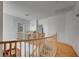 Upstairs hallway with wood flooring and railing at 10150 Timber Willow Ave, Las Vegas, NV 89135