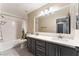 Bathroom with double vanity, large mirror, and bathtub at 10444 Britton Hill Ave, Las Vegas, NV 89129