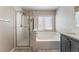 Clean bathroom with shower, bathtub, and modern vanity at 10444 Britton Hill Ave, Las Vegas, NV 89129