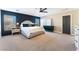 Main bedroom with dark blue accent wall and ceiling fan at 10444 Britton Hill Ave, Las Vegas, NV 89129