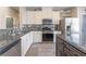 Modern kitchen featuring granite countertops and stainless steel appliances at 10444 Britton Hill Ave, Las Vegas, NV 89129