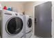 Laundry room with washer, dryer, and built-in shelving at 10444 Britton Hill Ave, Las Vegas, NV 89129