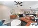 Open concept living room with a leather sectional and mid-century modern decor at 10444 Britton Hill Ave, Las Vegas, NV 89129