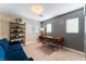 Home office with gray shiplap wall and blue couch at 10444 Britton Hill Ave, Las Vegas, NV 89129