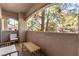 Private balcony with wicker furniture and treetop views at 108 Breezy Tree Ct # 202, Las Vegas, NV 89145