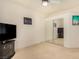 Bedroom with mirrored closet doors and a TV at 108 Breezy Tree Ct # 202, Las Vegas, NV 89145