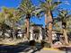 Inviting community entrance with palm trees and Spanish-style architecture at 108 Breezy Tree Ct # 202, Las Vegas, NV 89145