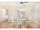 Dining area with glass top table and four white chairs at 108 Breezy Tree Ct # 202, Las Vegas, NV 89145