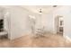 Dining area with glass table and white chairs near kitchen at 108 Breezy Tree Ct # 202, Las Vegas, NV 89145